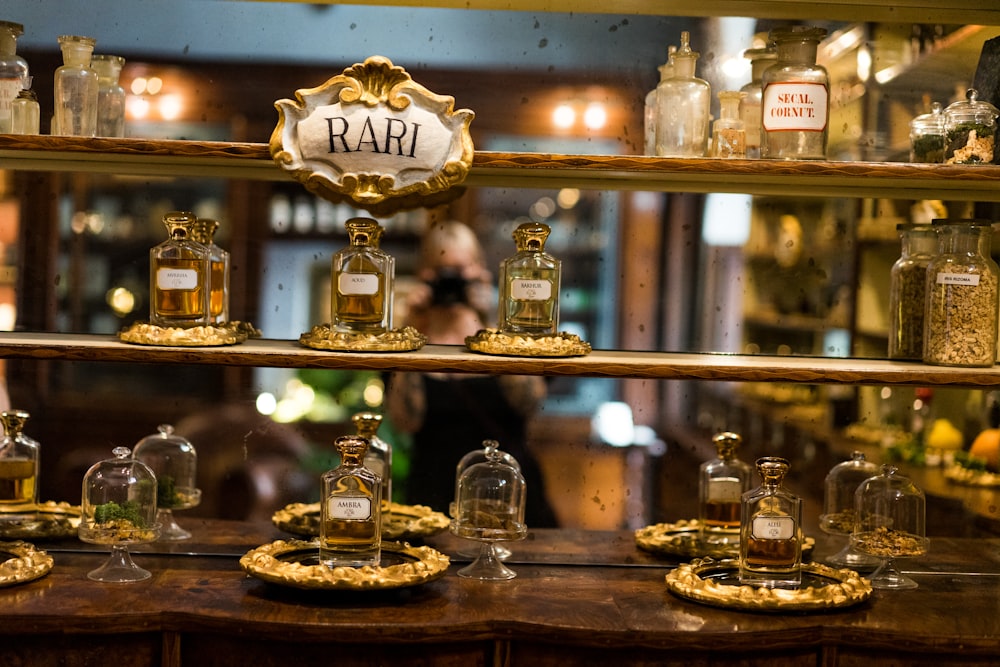 a shelf with glass jars and bottles