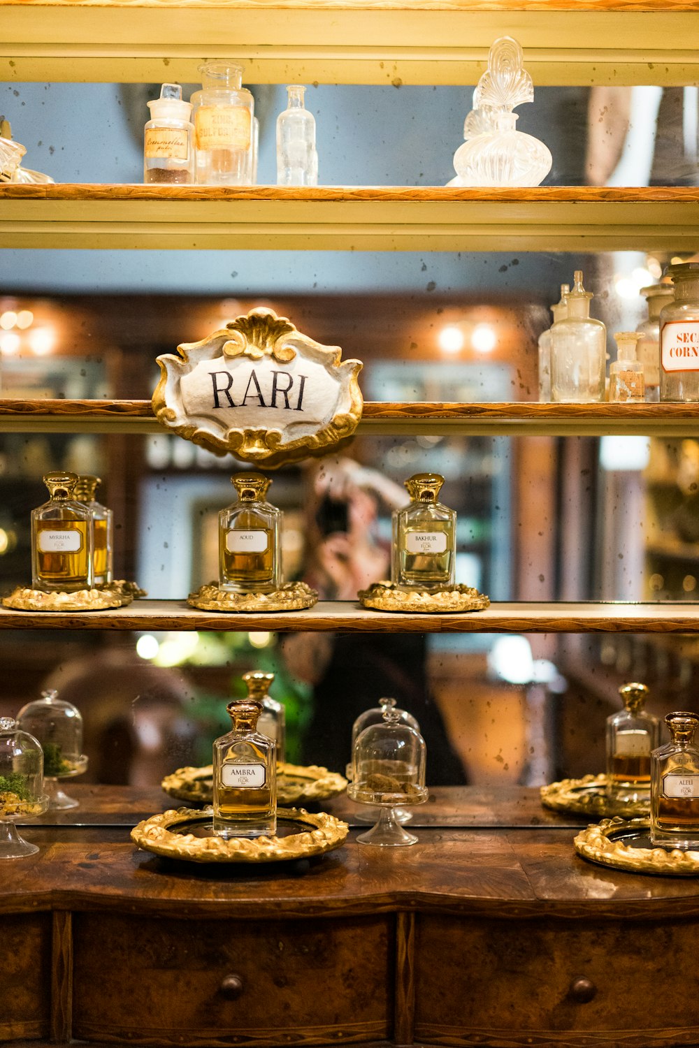 a shelf with glass jars and bottles