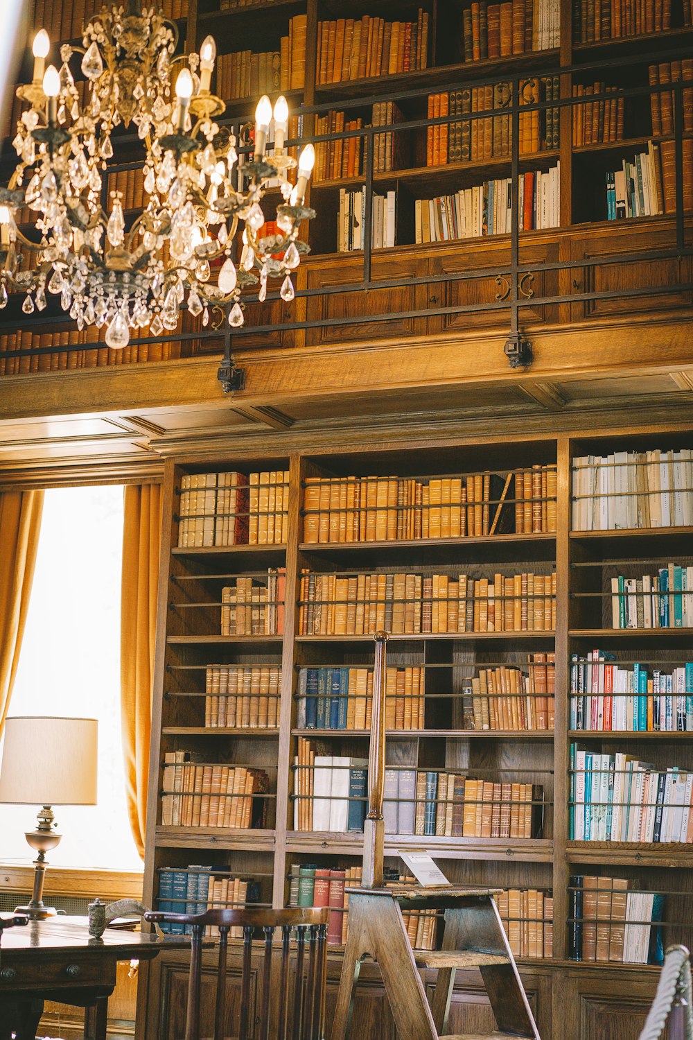 a room with bookshelves and a chandelier