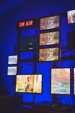 a wall with many screens and a keyboard