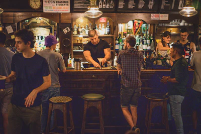 a group of people standing around a bar