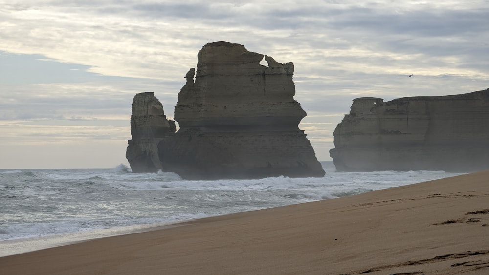 a group of large rocks in the water