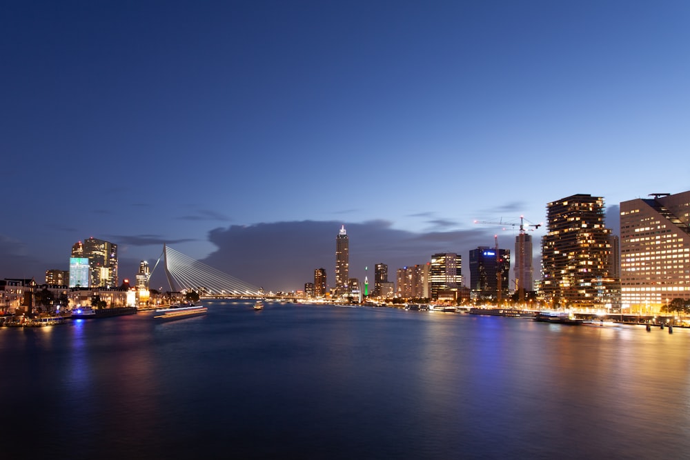 a bridge over a body of water with buildings in the background