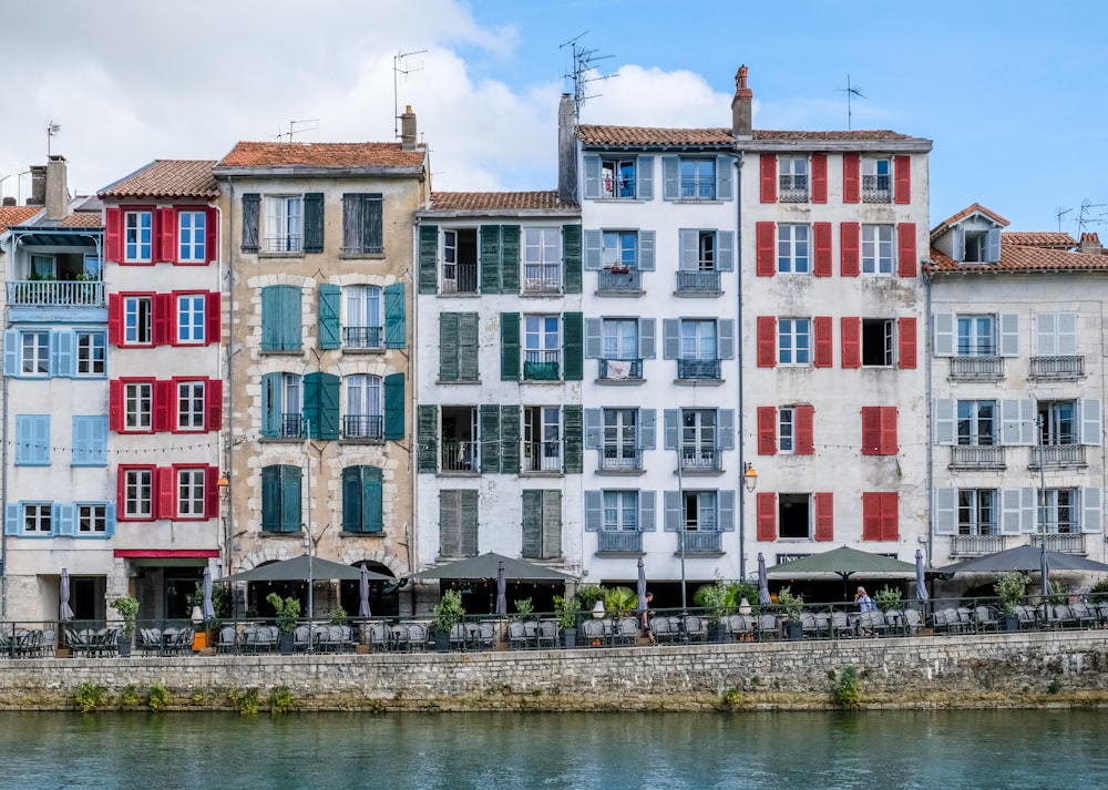 a row of buildings next to a body of water