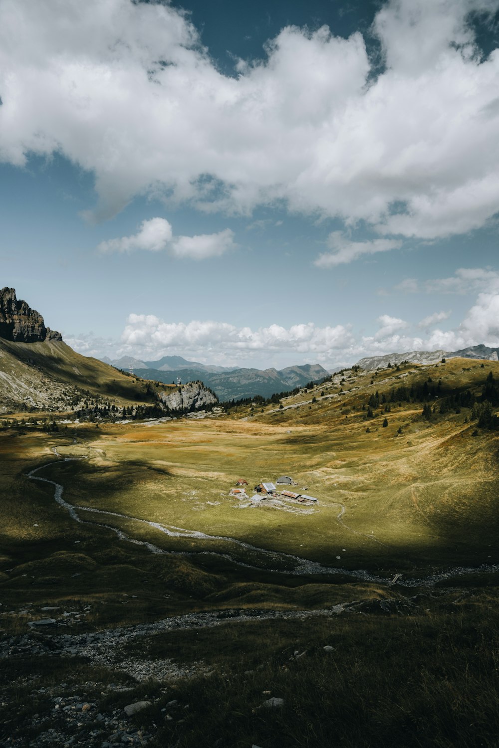 a landscape with mountains and clouds