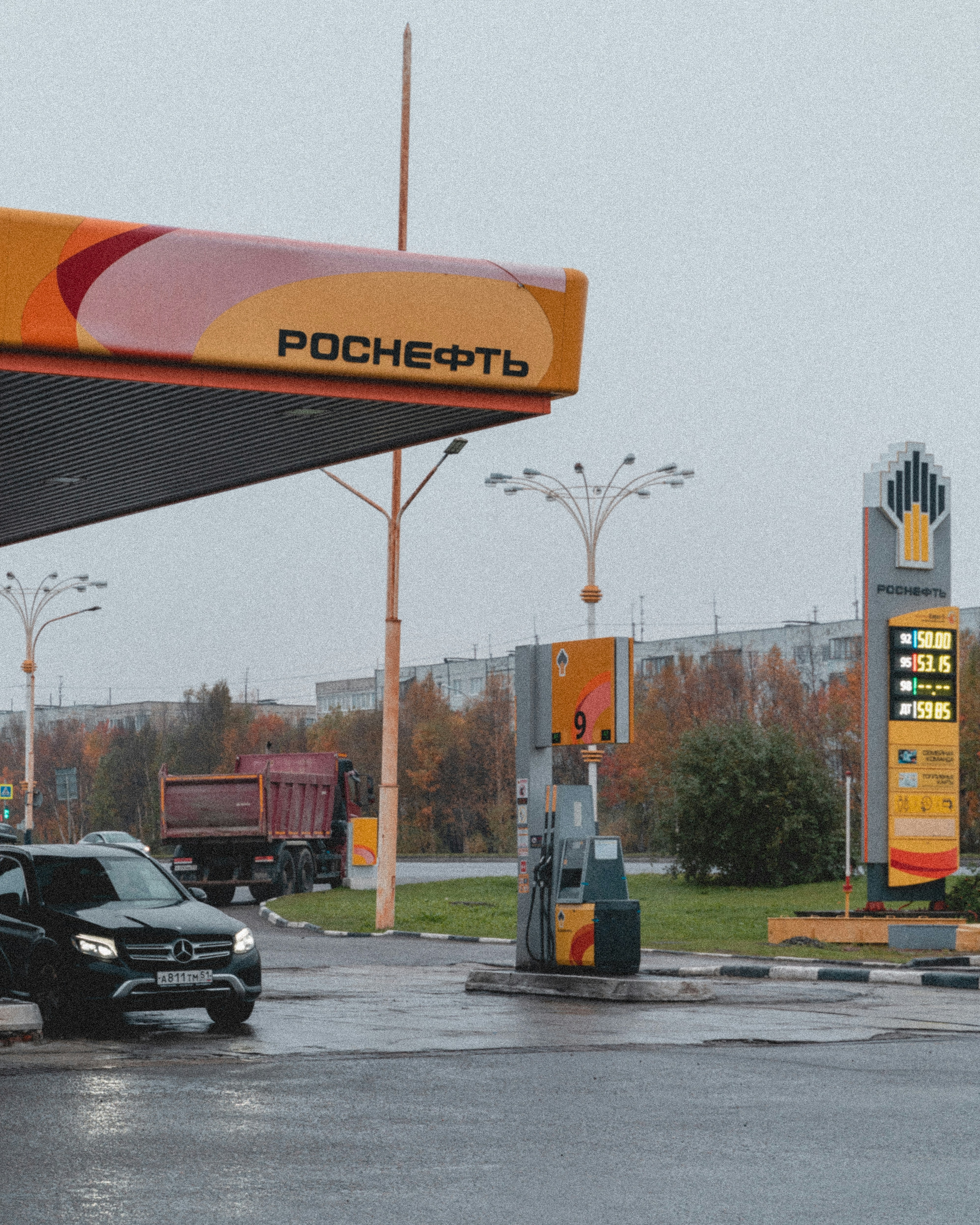 a gas station with a car parked in front of it