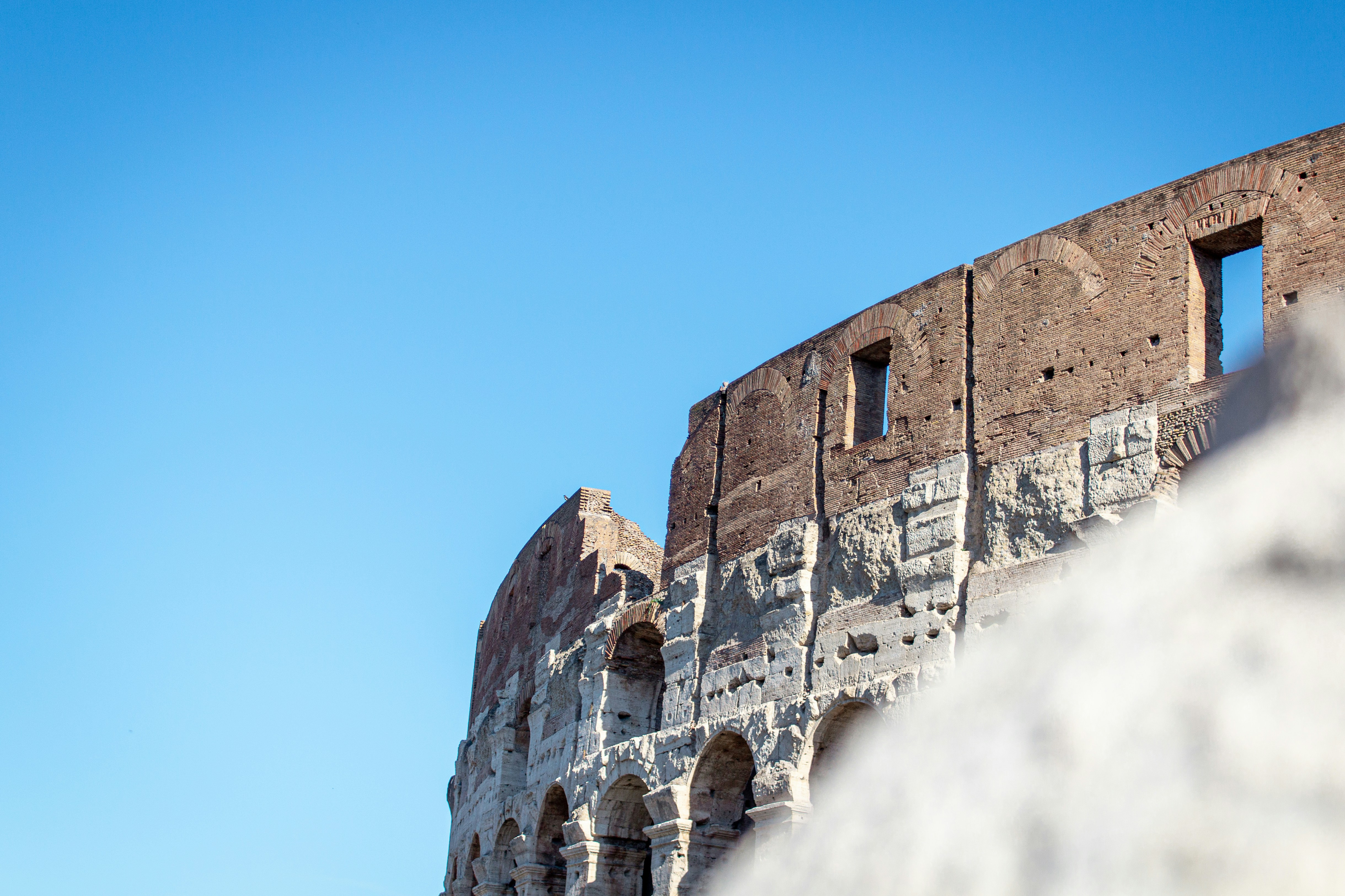 a stone building with a cloudy sky