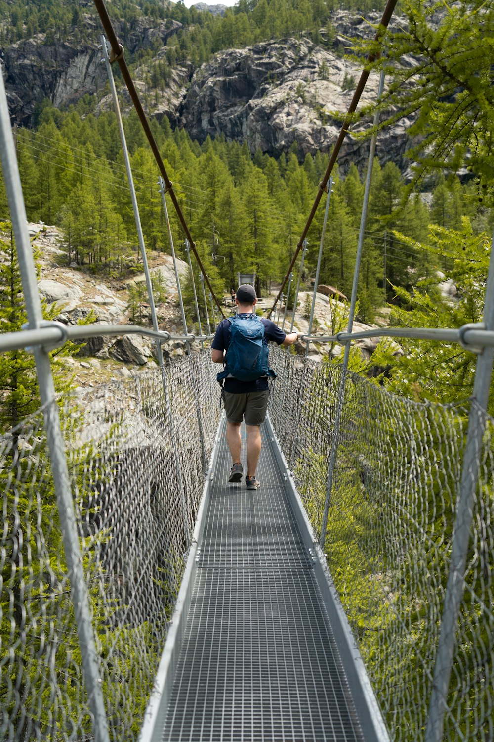 a person walking on a suspension bridge