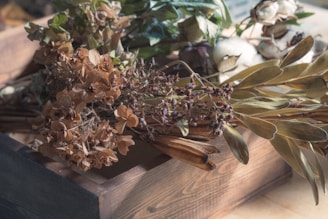A creative flower arrangement in a wooden box with mixed seasonal blooms.