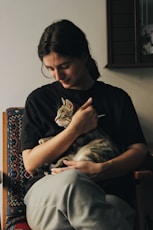 a person holding a cat