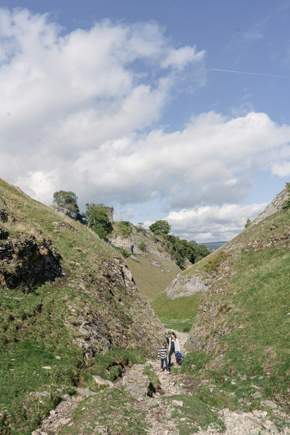 people walking on a rocky path