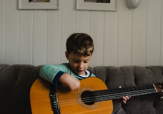 a boy playing a guitar