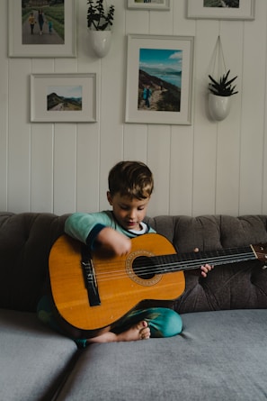 a boy playing a guitar