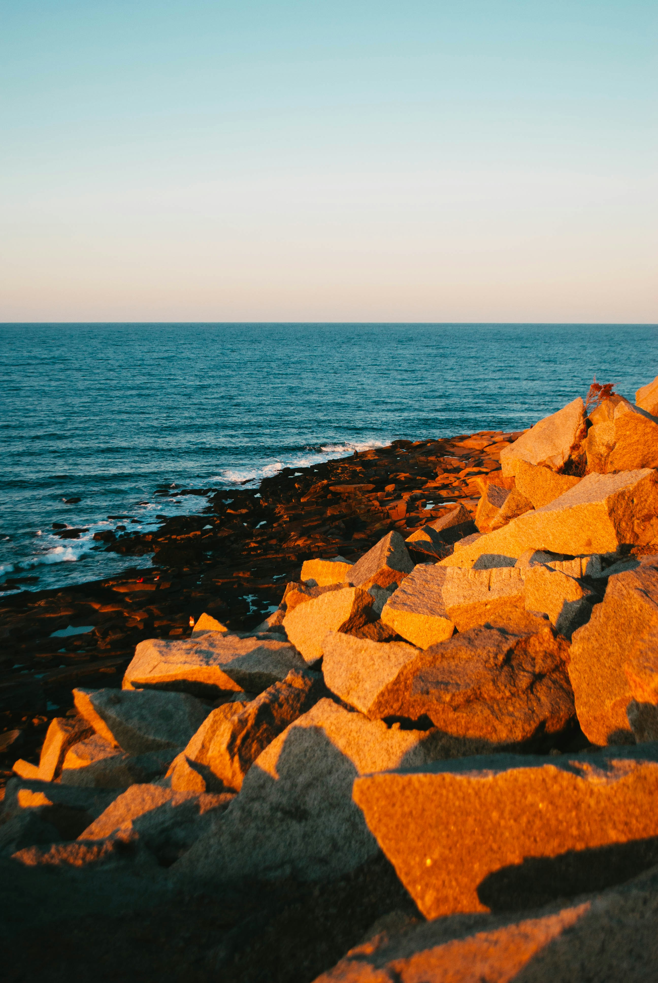 a rocky beach with water in the background