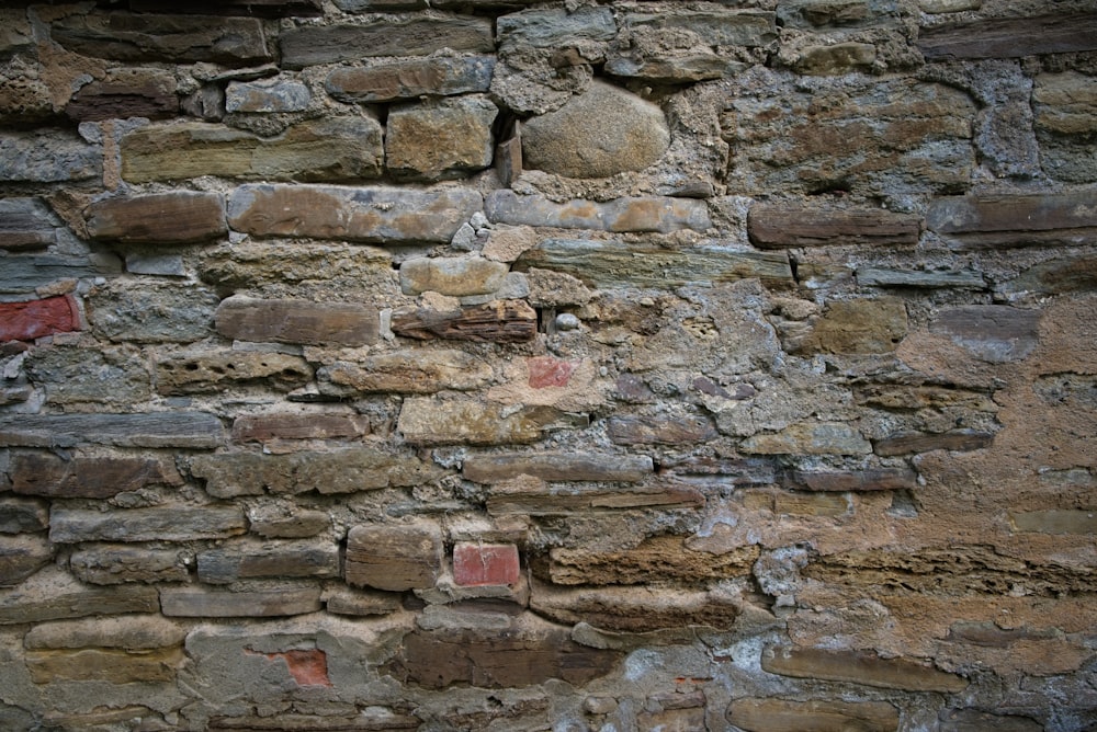 a stone wall with a brick wall