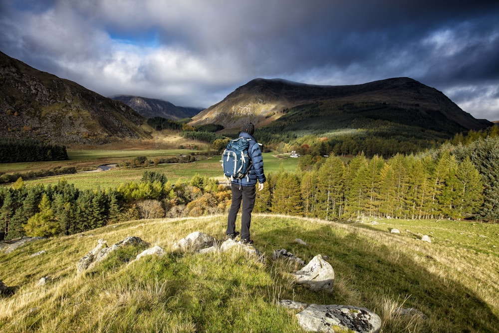 a person walking on a trail in a mountainous region