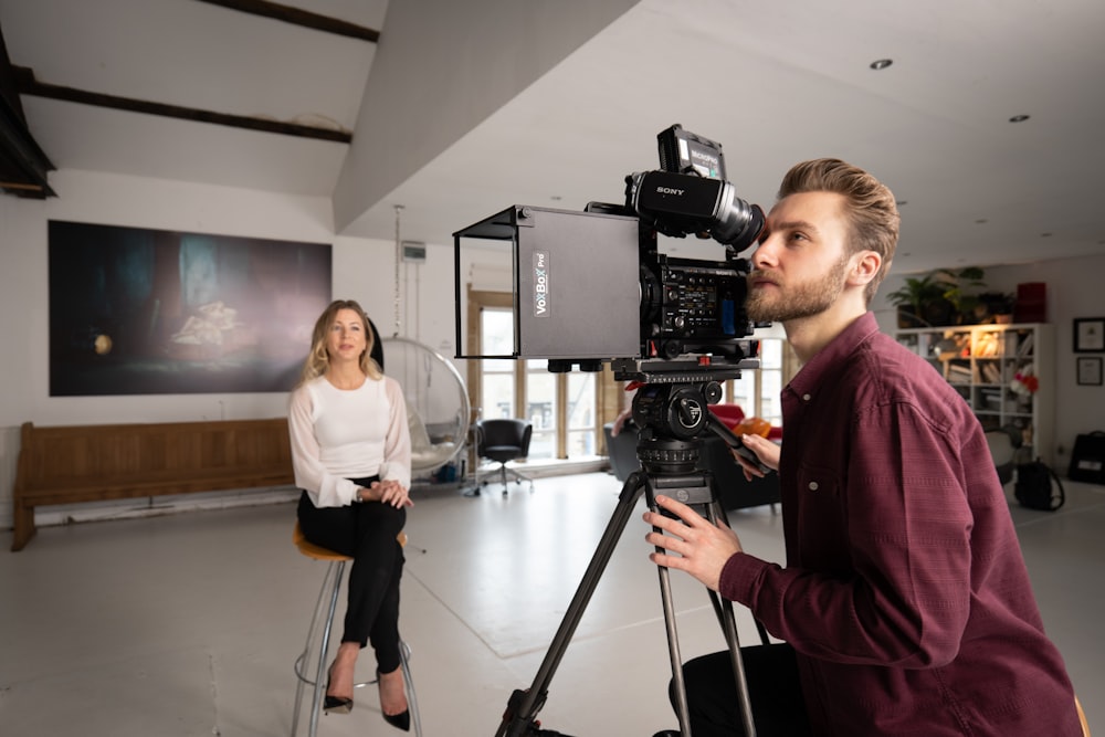 a man standing next to a camera