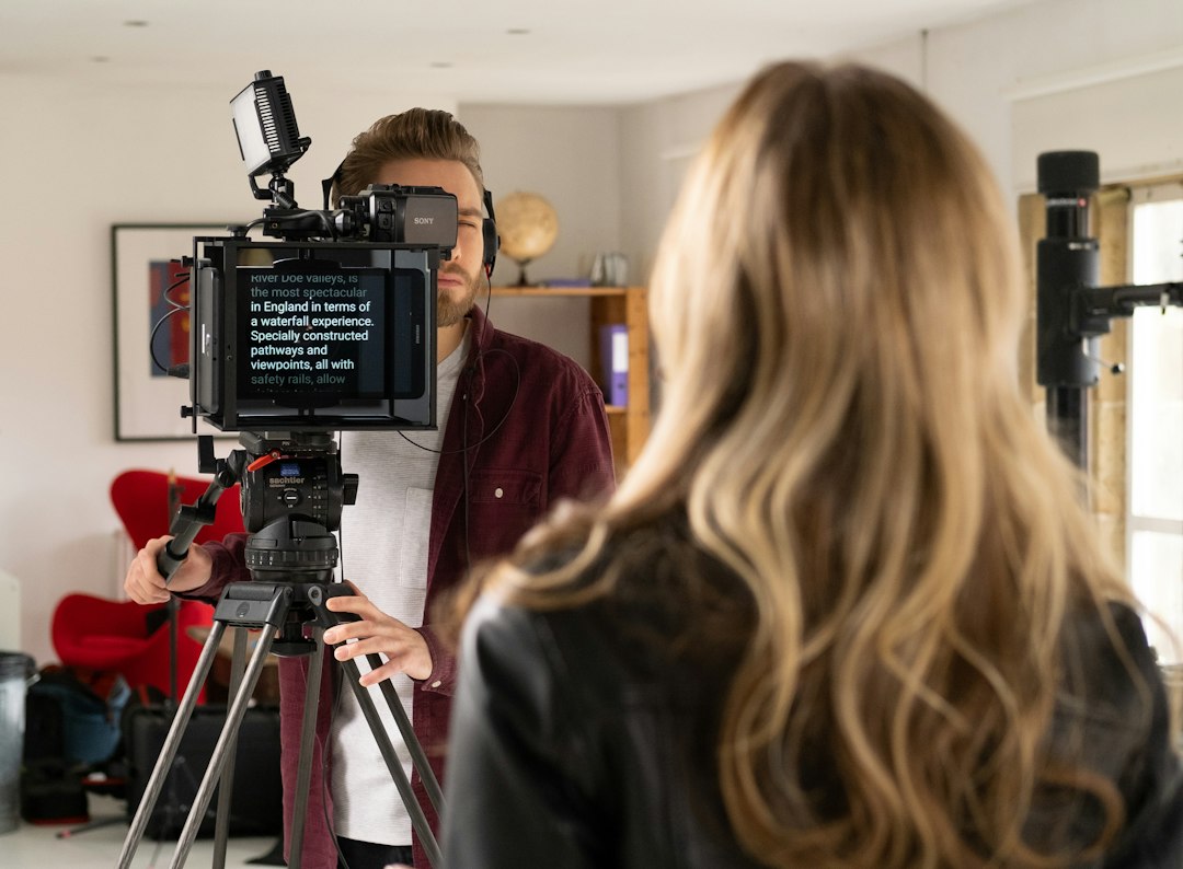A presenter recording a video with a camera and teleprompter