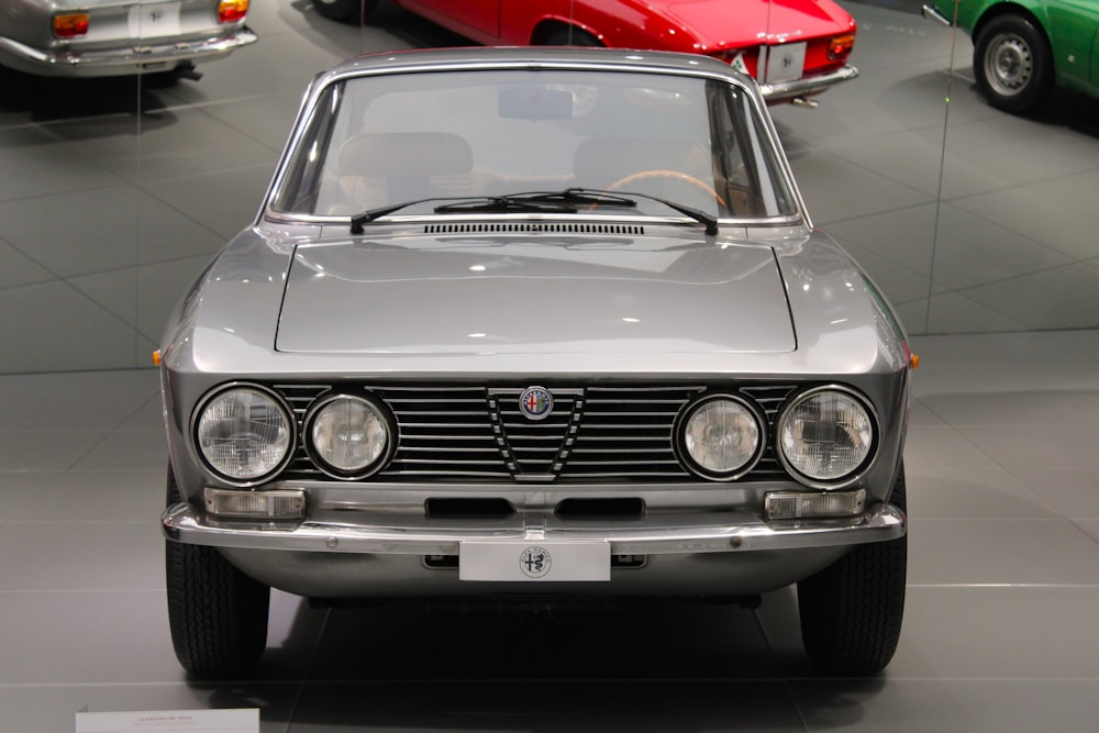 a silver car parked in a showroom