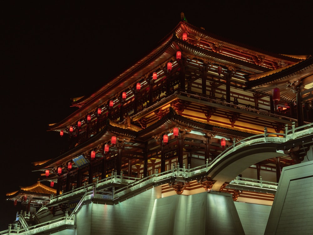 a large asian building with red lanterns