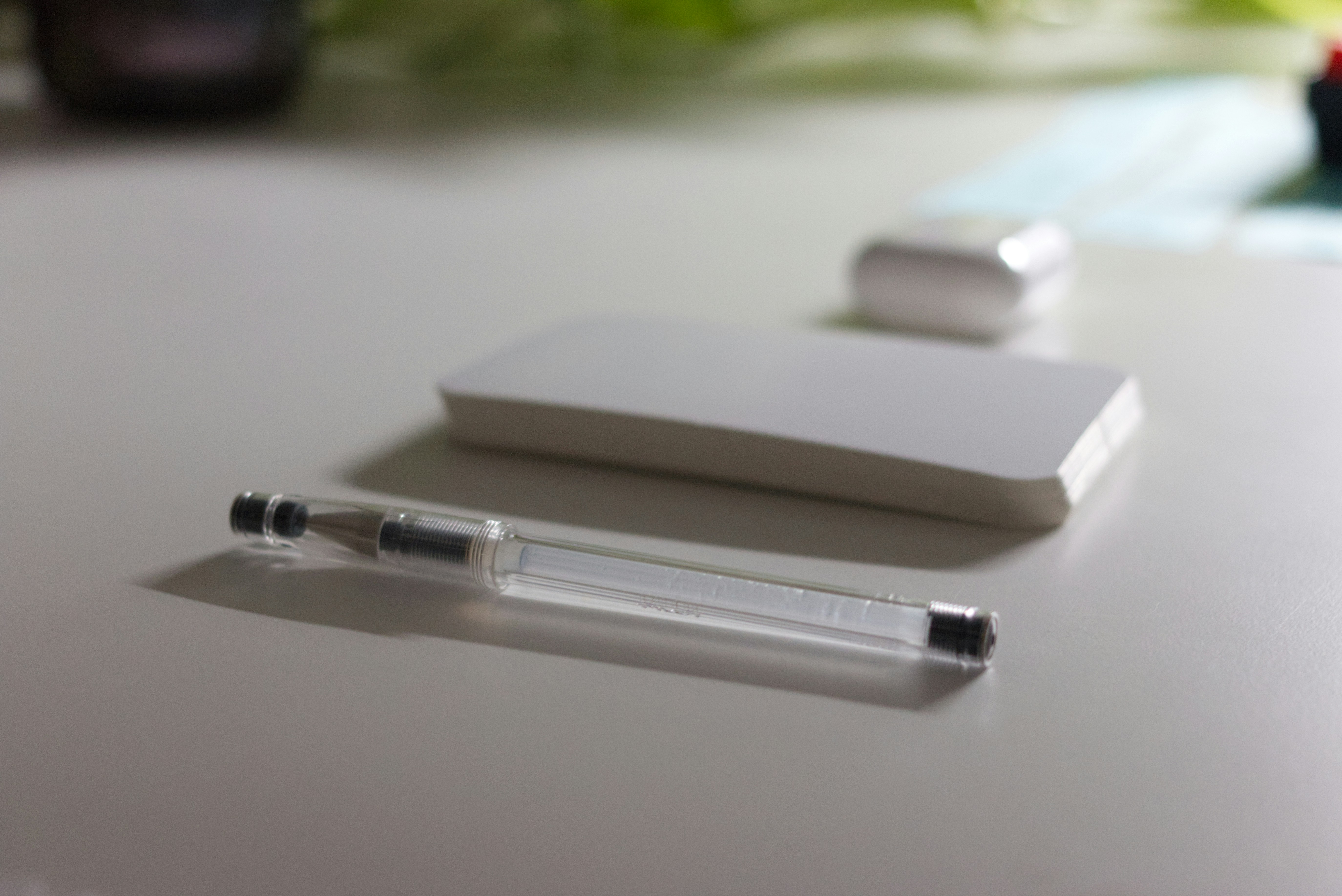 a pen and a stylus on a white surface