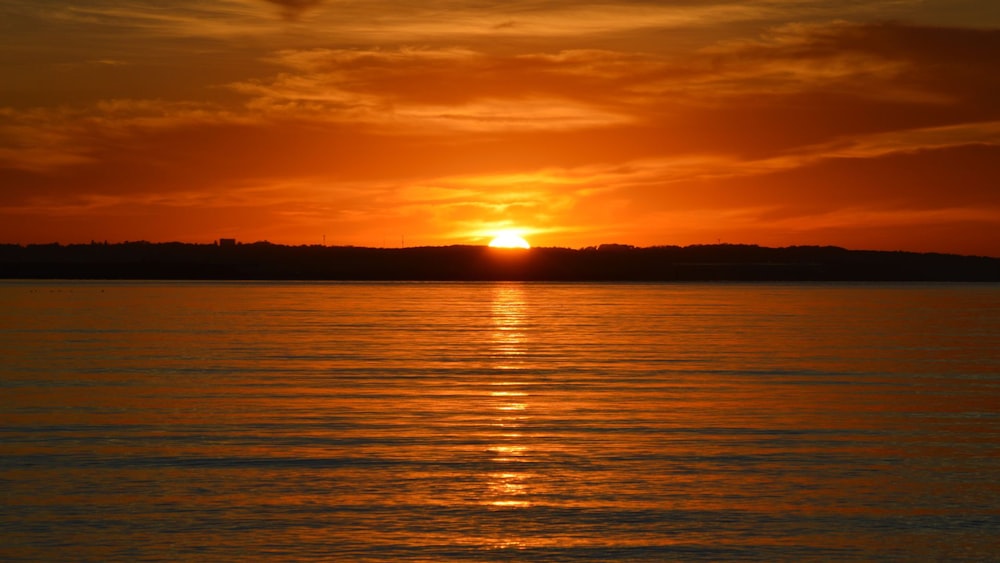 a sunset over a body of water