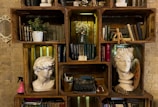 A rustic shelf displaying used books and charming decorative items.