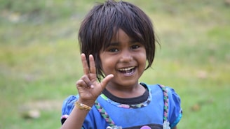 a girl smiling and holding her hands up