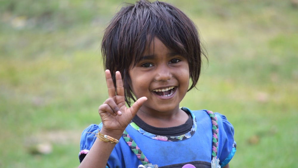 a girl smiling and holding her hands up