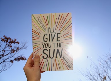 a hand holding a book