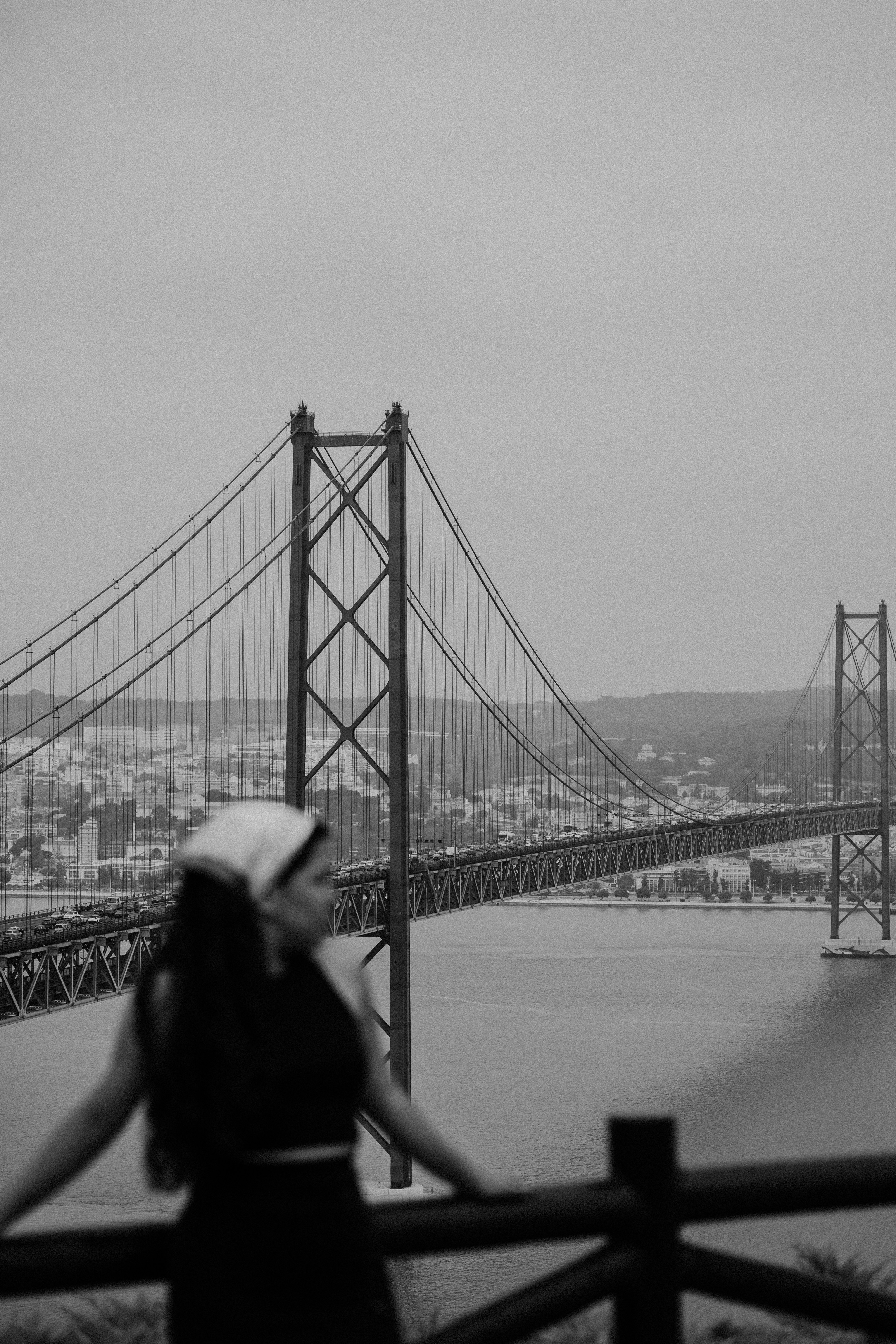 A person standing on a bridge photo – Free Lisbon Image on Unsplash