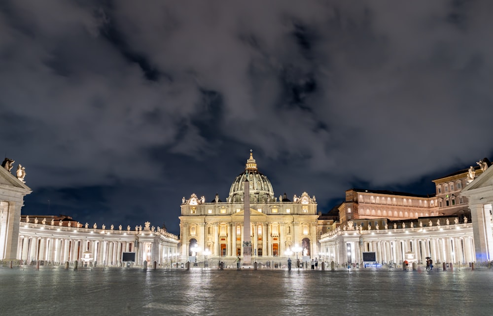 a large building with a dome and a cloudy sky