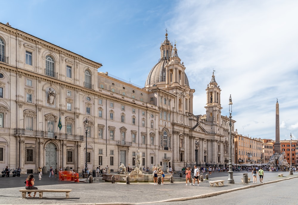 a large building with a dome and many windows with Piazza Navona in the background