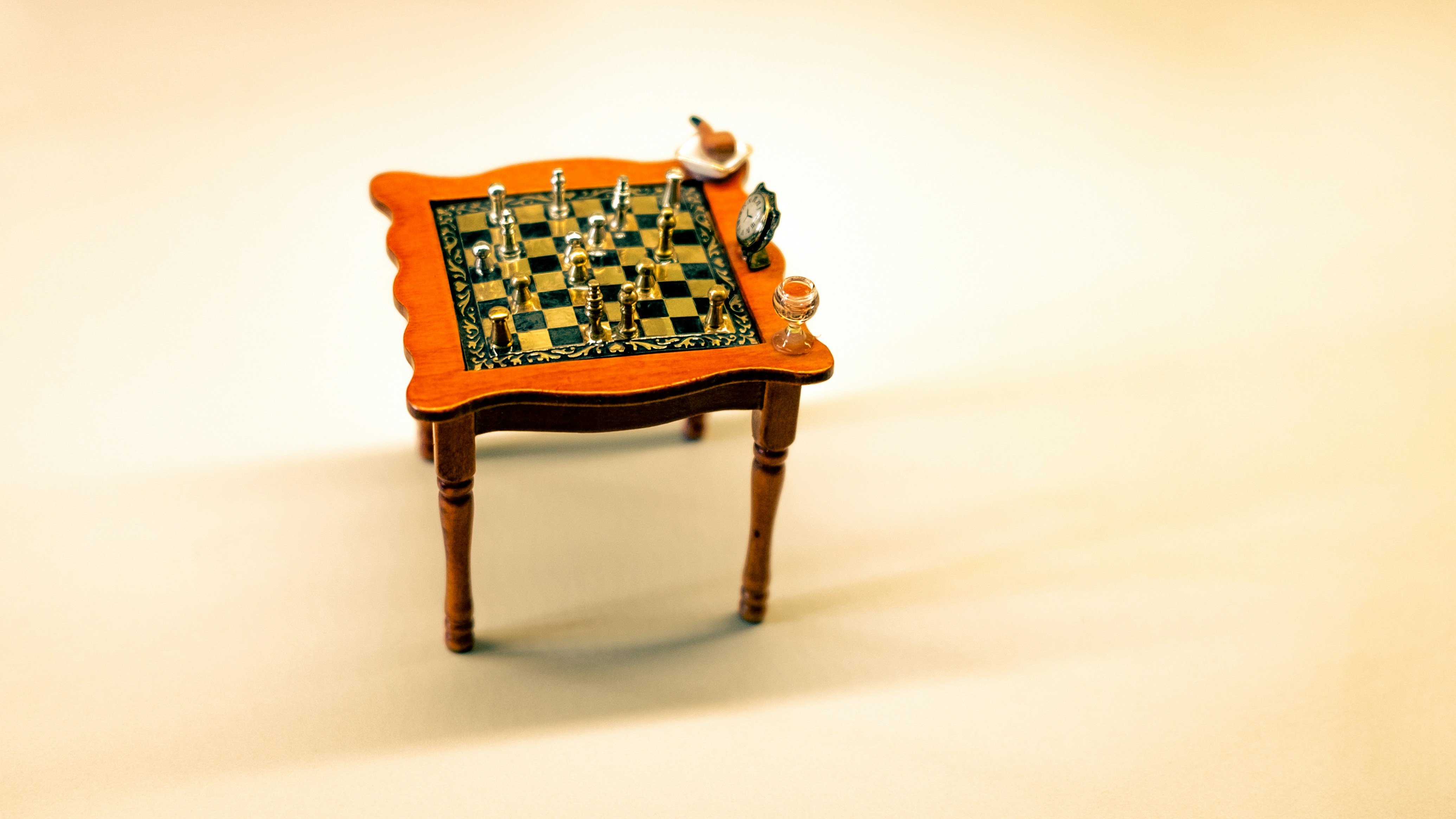 a wooden chair with a table and a lamp on top