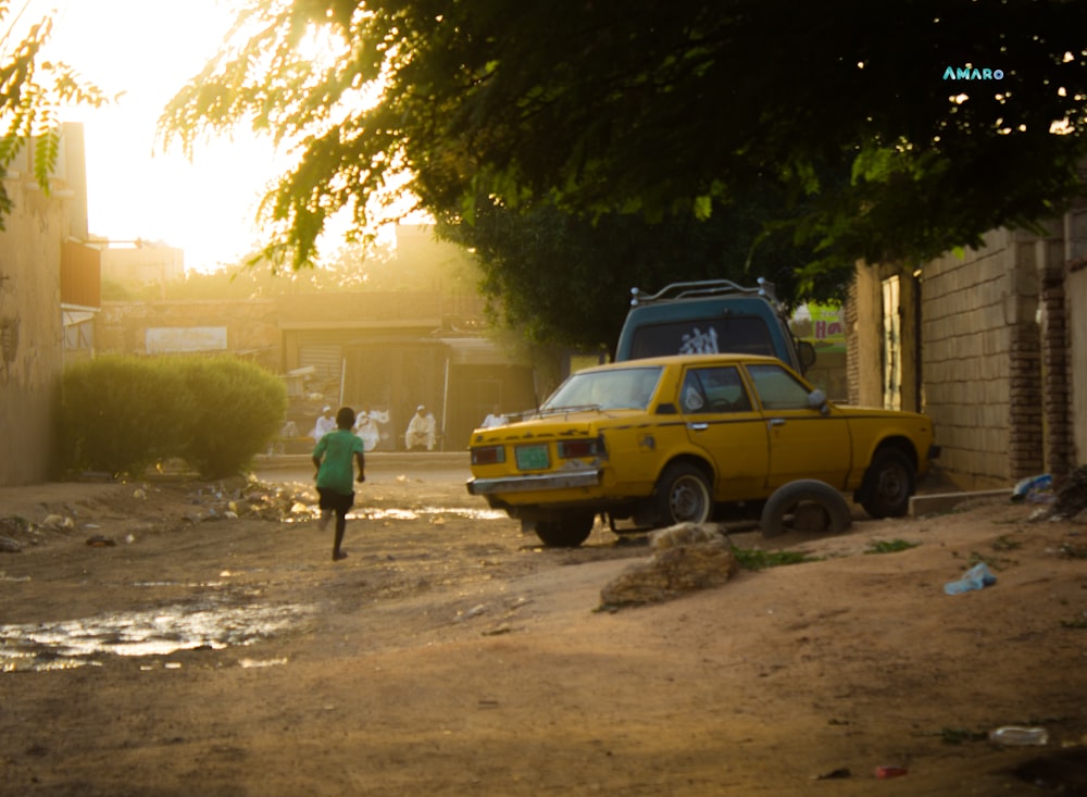 a yellow truck parked on a dirt road