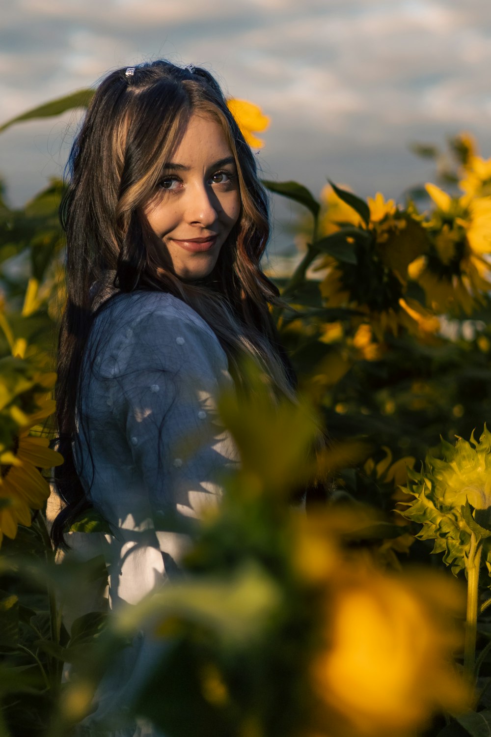 a person standing in a field of flowers