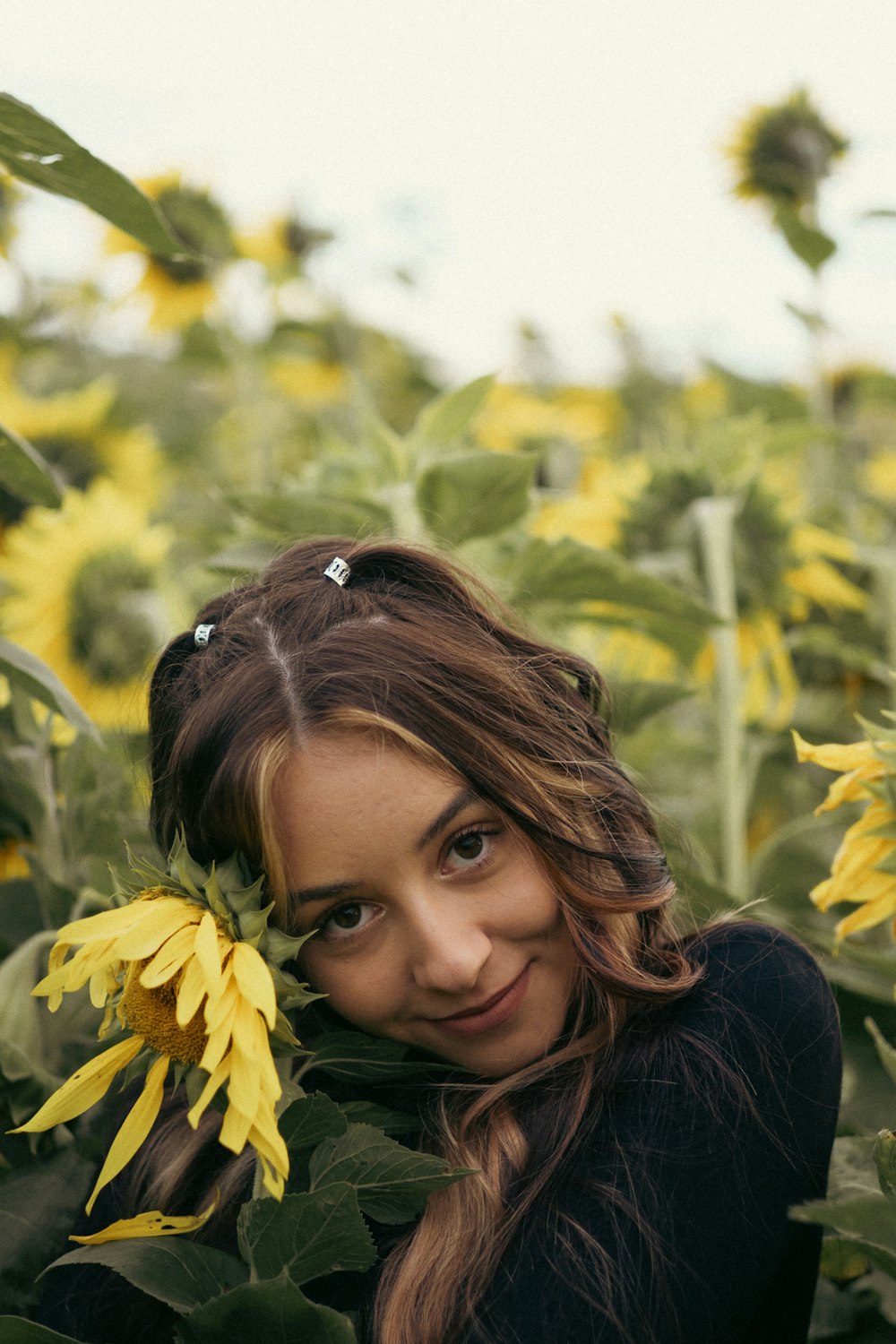 a woman smiling with a flower in her hair