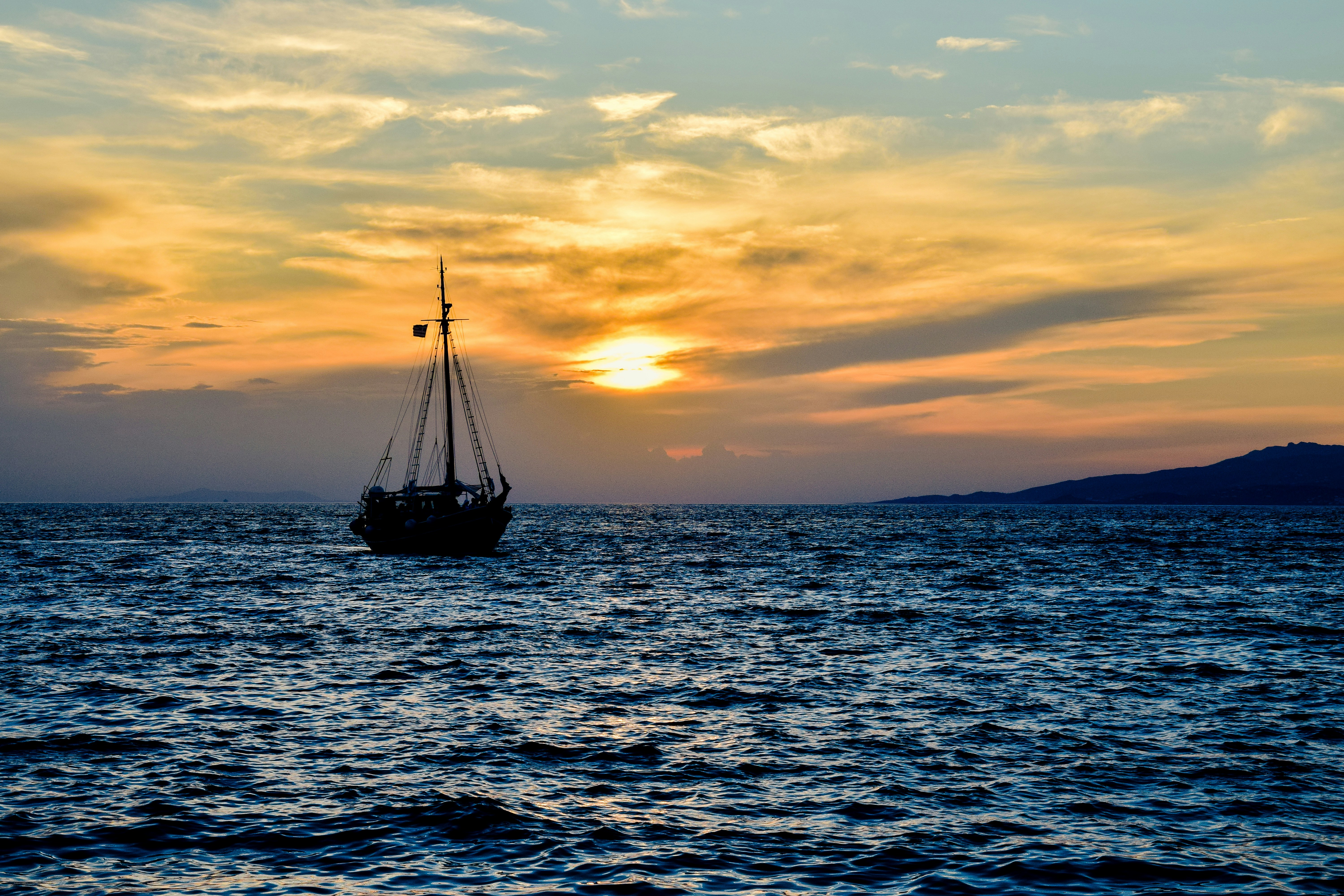 a boat sailing in the sea, Mykonos, Greece.