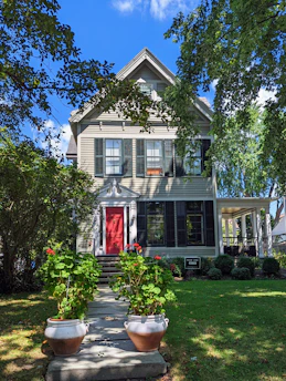A freshly painted exterior of a cozy house featuring rich, inviting colors.