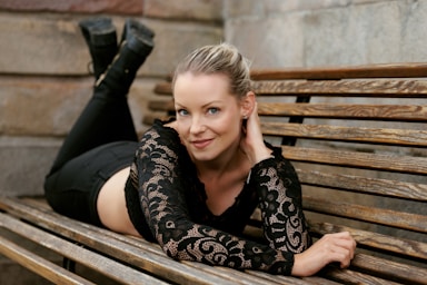 photography poses for women,how to photograph portrait of a beautiful young woman dressed in black lying on a bench. model sofie (instagram: @sofiepersson87) in stockholm, sweden.; a person sitting on a bench