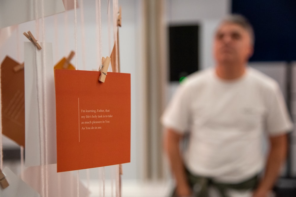 a man standing next to a sign