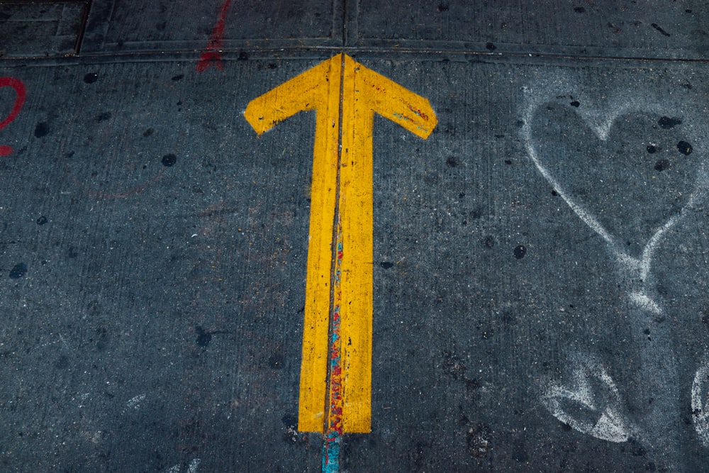 a yellow triangle on a road