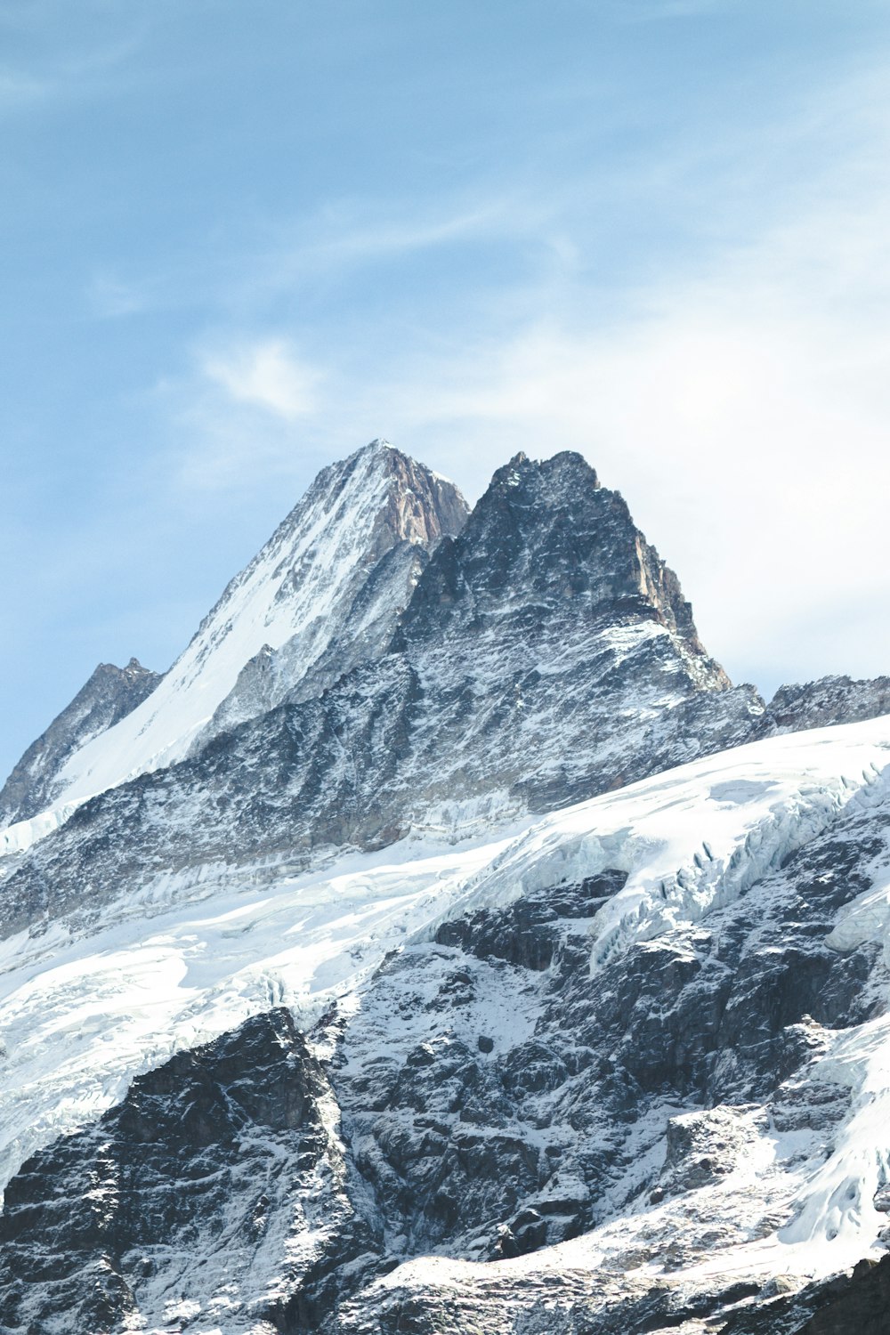 a snowy mountain with a blue sky