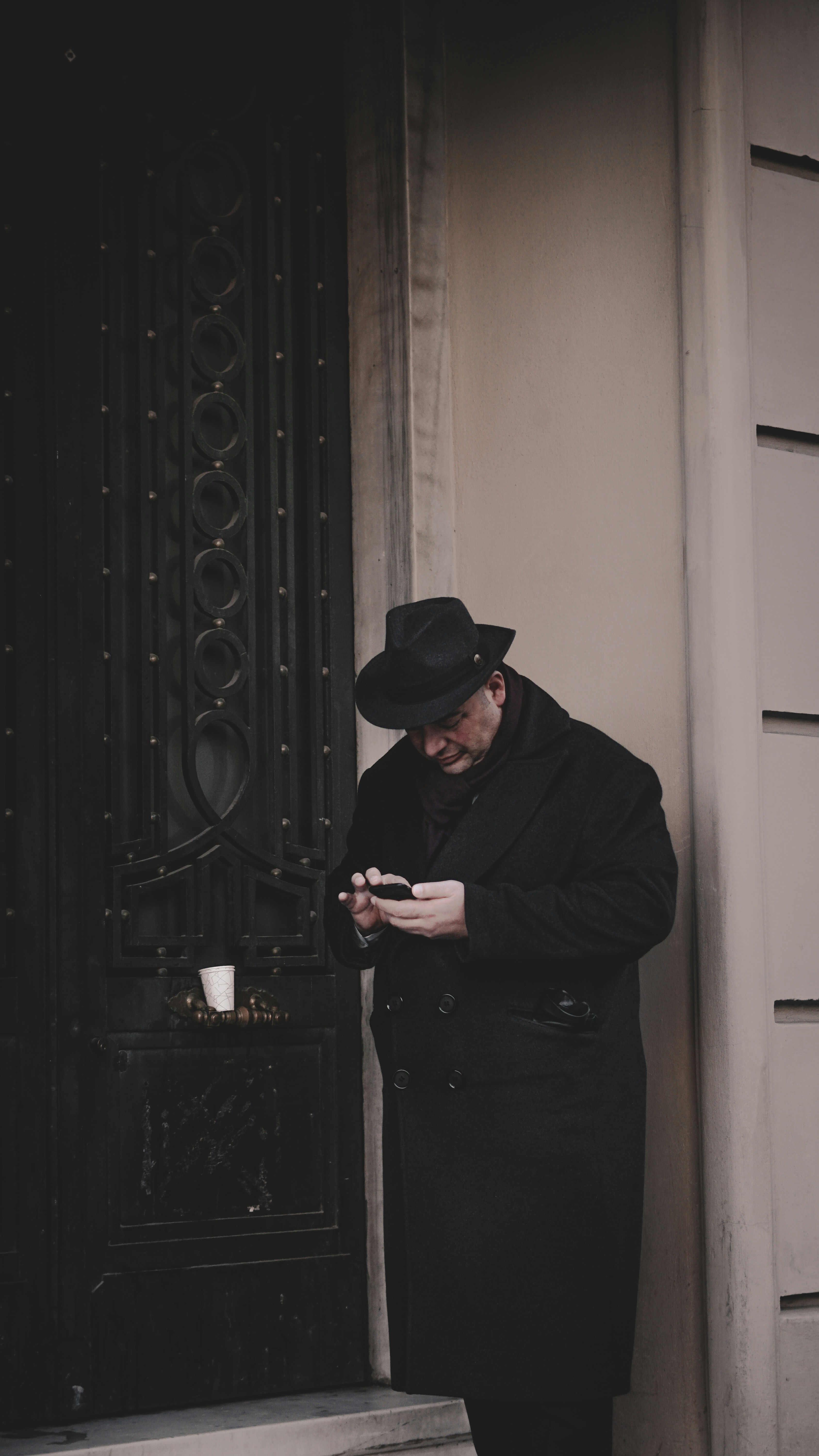 a man in a black hat looking at his phone