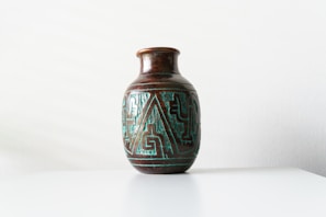 Close-up of a vibrant handmade ceramic vase with intricate patterns