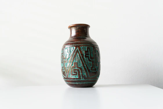 Close-up of a hand-painted ceramic vase showcasing intricate patterns and rich colors.