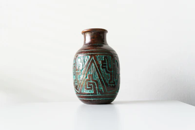 Close-up of a sleek 3D printed vase with intricate geometric patterns on a minimalist white background