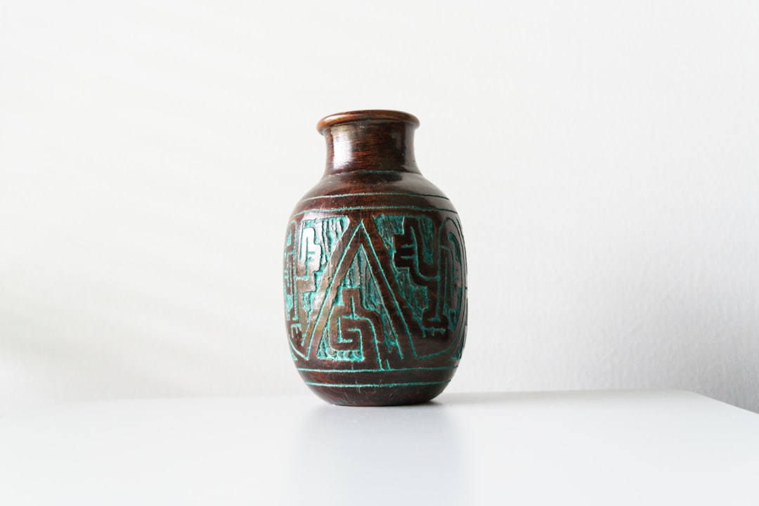 a glass vase with a blue and green design,