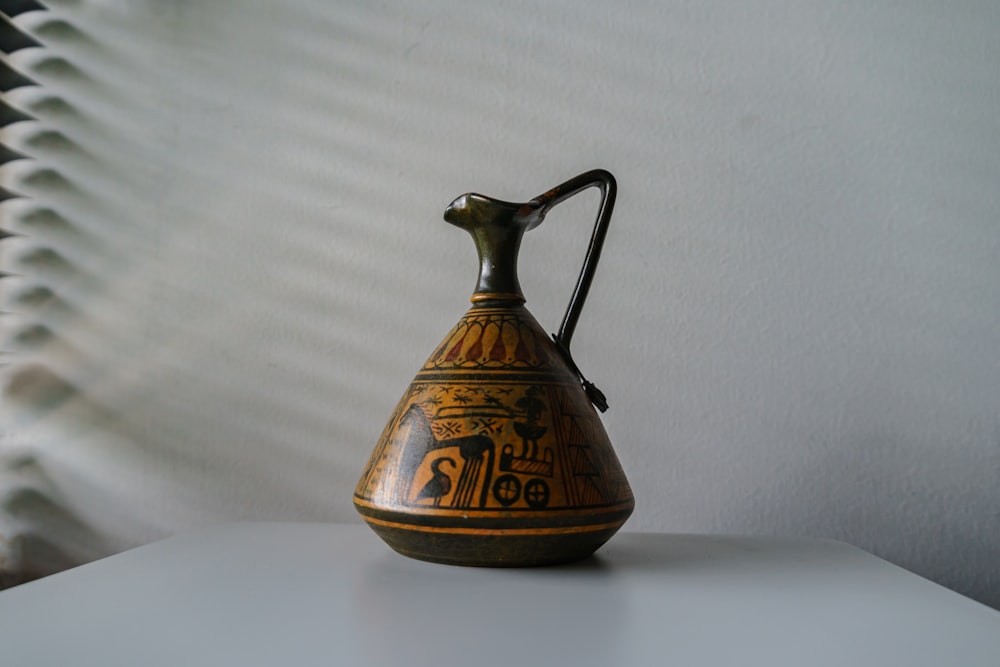 a glass teapot on a table