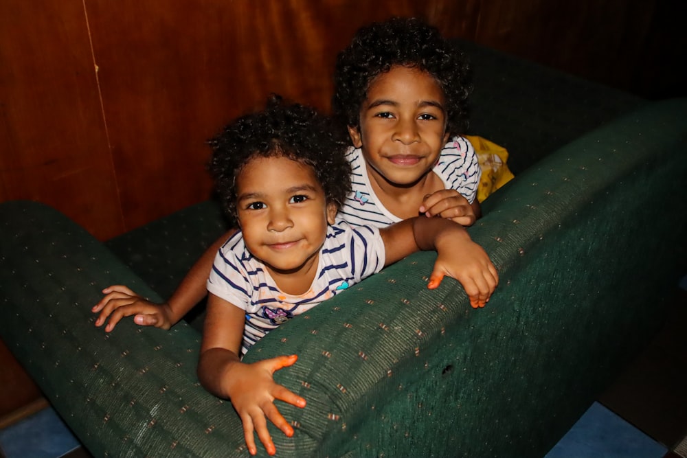 a couple of children in a green slide